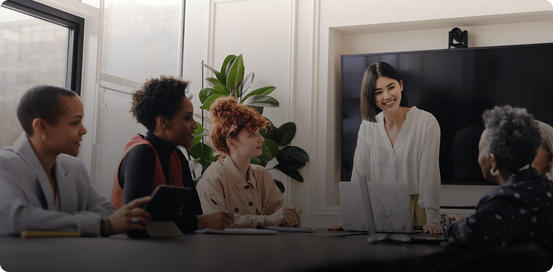 Team meeting with diverse group around table.