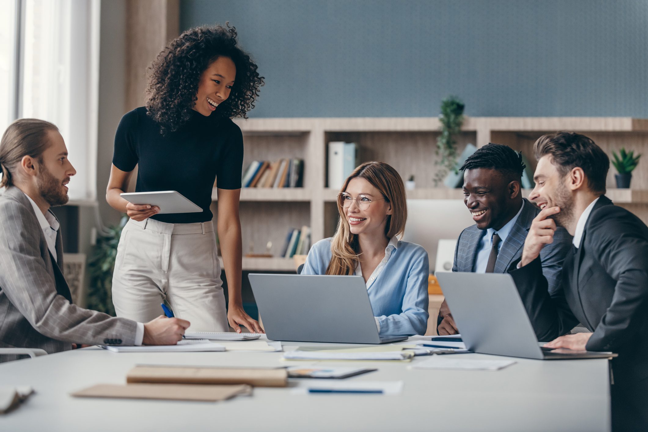Diverse team having a meeting, smiling together.